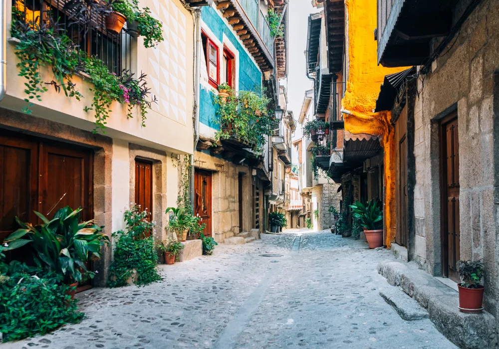 village street in spain, cobblestoned streets and bright coloured walls