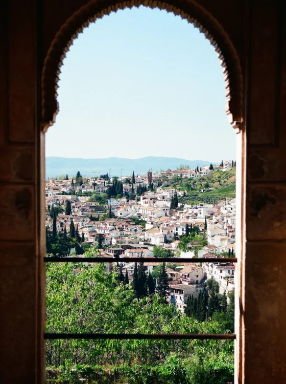 spanish village view through an arched balcony doorway